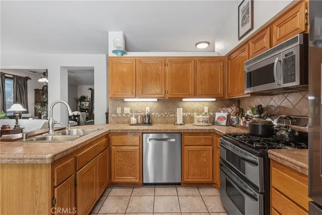 a kitchen with a sink stove top oven and cabinets