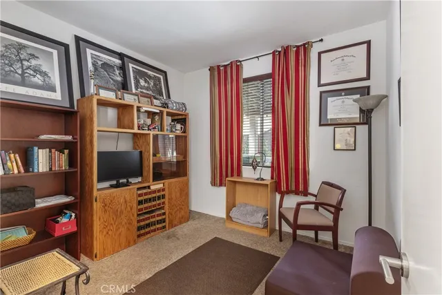a living room with furniture cabinets and flat screen tv