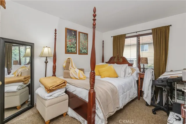 a bedroom with a bed and glass walk in closet