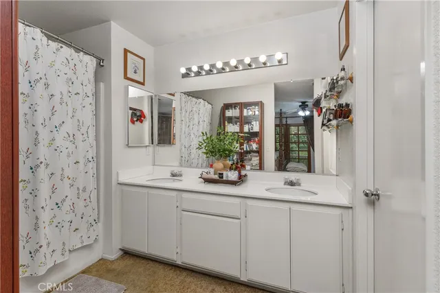 a bathroom with a sink vanity and a mirror