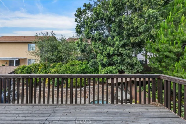 a balcony with wooden floor and fence