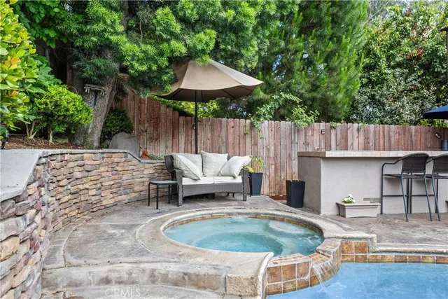 a backyard of a house with table and chairs