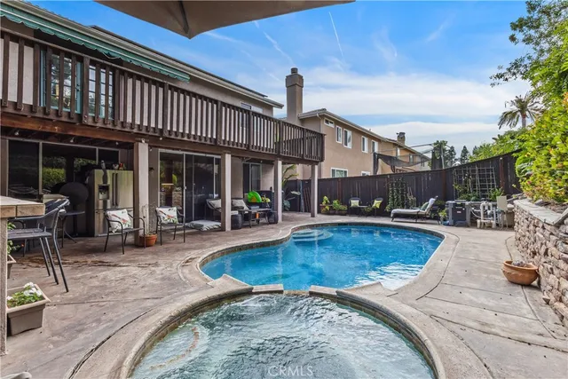 a view of a house with swimming pool and sitting area