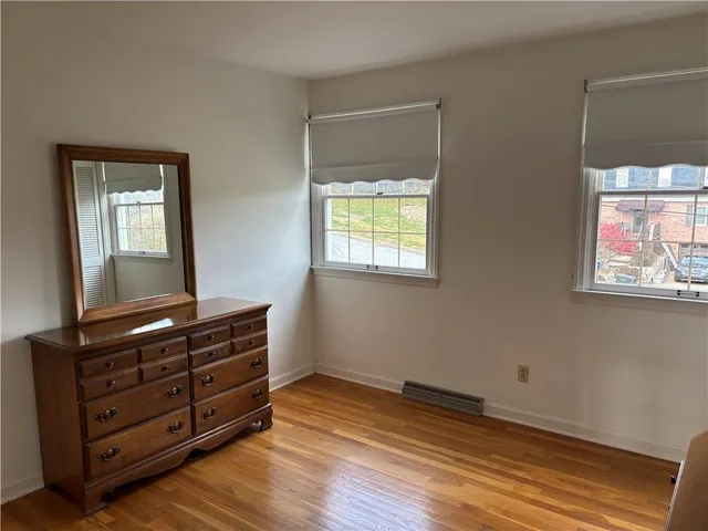 a view of room with wooden floor
