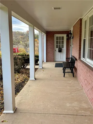 a view of two chairs in a room with a window
