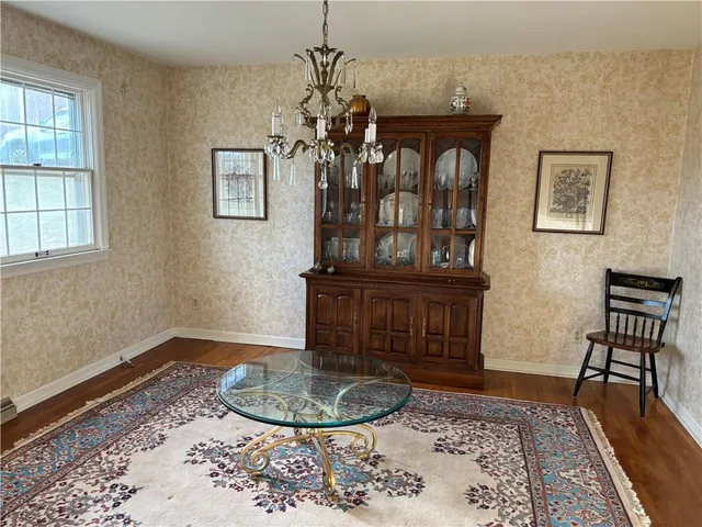 a view of a livingroom with furniture window and wooden floor