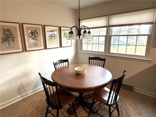 a view of a dining room with furniture and window