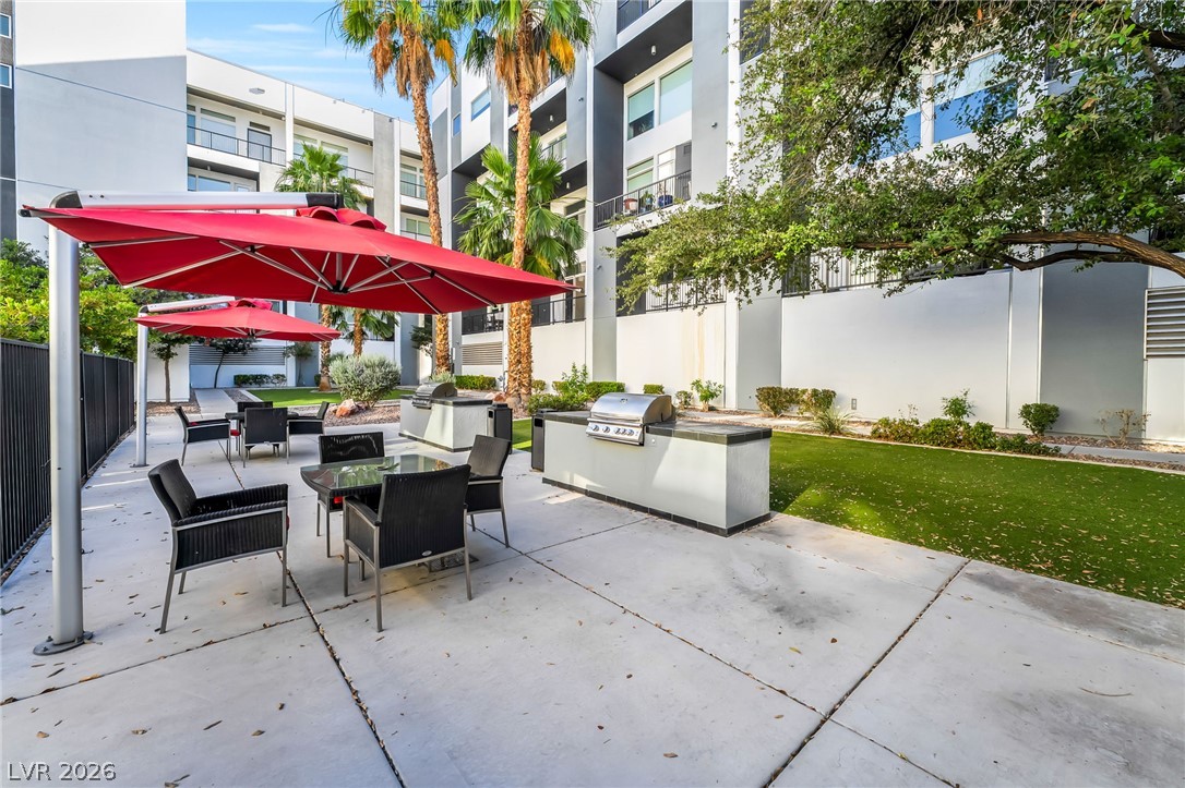 2775 West Pebble Road, Unit 505 Las Vegas, NV 89123 - Photo 26 of 26 A community outdoor entertaining space with built-in barbecue grills and shaded dining areas.