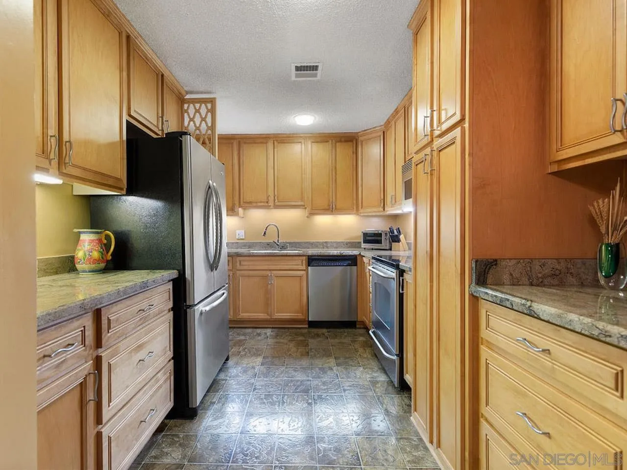 800 Prospect Street, Unit 4A La Jolla, CA 92037 - Photo 23 of 34 a kitchen with a refrigerator sink and cabinets
