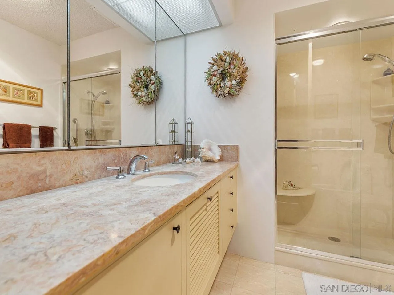 800 Prospect Street, Unit 4A La Jolla, CA 92037 - Photo 28 of 34 a bathroom with a granite countertop sink a mirror and shower