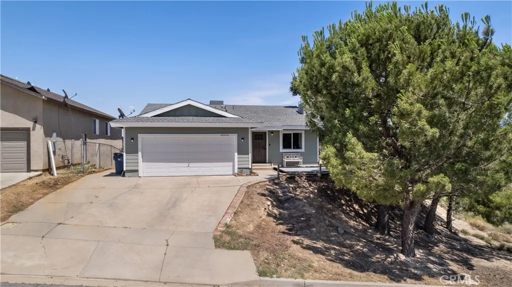 42614 Cabin Rd Lake Tehachapi, CA 93561 - Photo 1 of 1 a front view of a house with a garden and yard