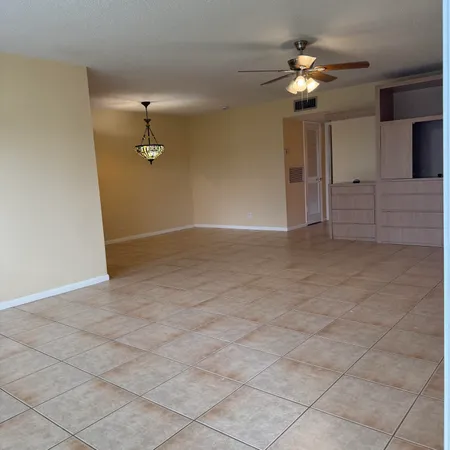 an empty room with fan and entrance