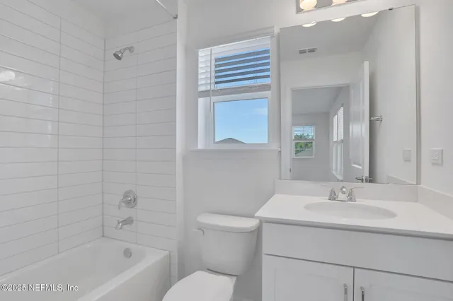 a bathroom with a sink a toilet and bathtub