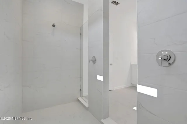 a bathroom with a glass shower door