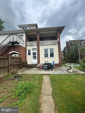 a view of a house with backyard porch and sitting area