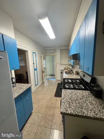 a kitchen with a stove a refrigerator and cabinets