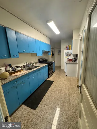 a kitchen with cabinets and chairs