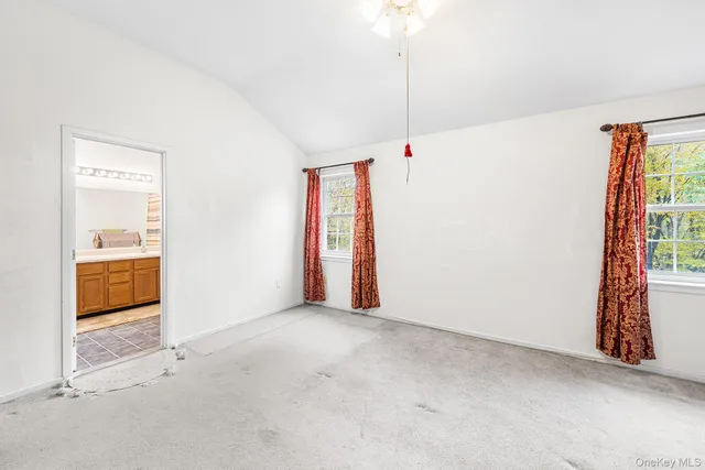 a view of an empty room and a window