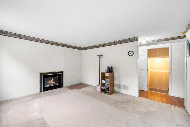 a view of an empty room with a fireplace