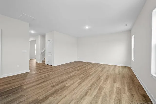 a view of an empty room and wooden floor