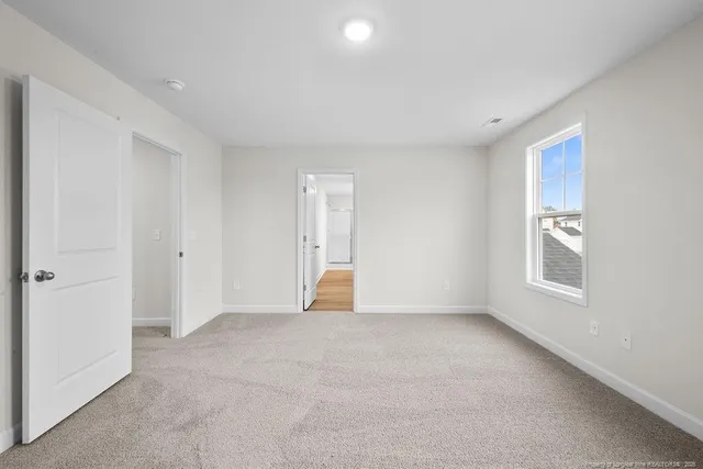 an empty room with a empty space and windows