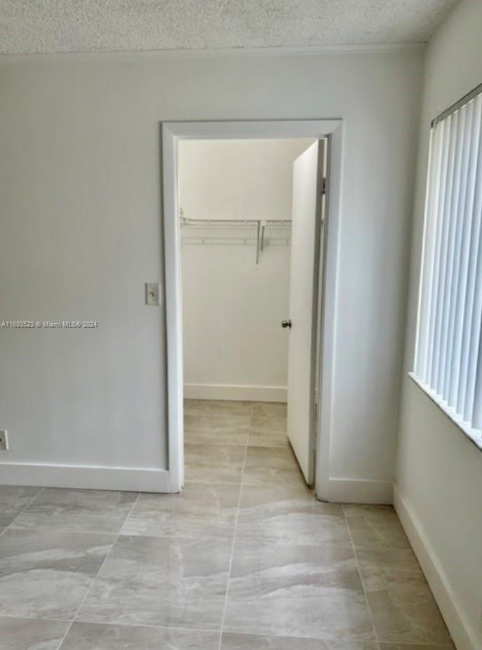 5720 Rock Island Road, Unit 385 Tamarac, FL 33319 - Photo 4 of 9 a view of an empty room with window and closet area
