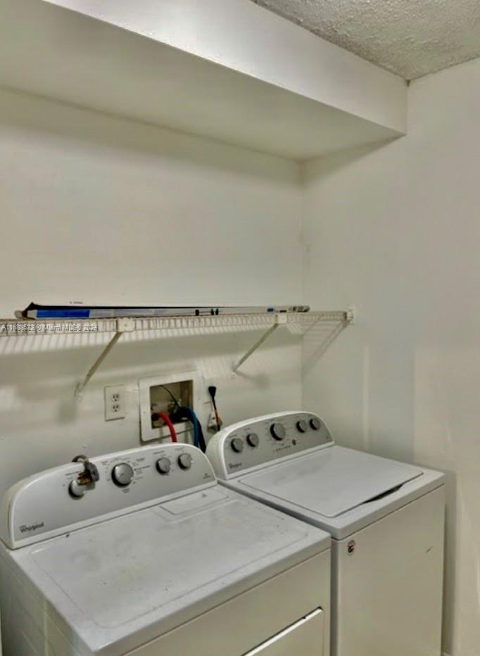 5720 Rock Island Road, Unit 385 Tamarac, FL 33319 - Photo 6 of 9 a utility room with dryer and washer