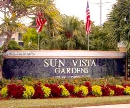 5720 Rock Island Road, Unit 385 Tamarac, FL 33319 - Photo 7 of 9 a view of outdoor space with signage and flags