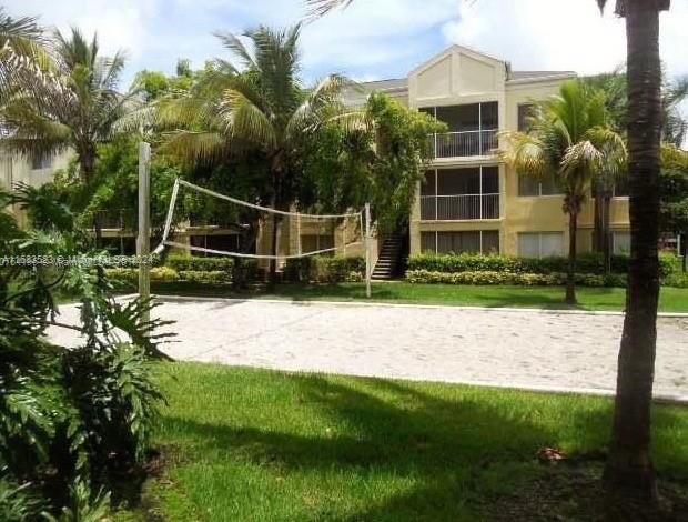 5720 Rock Island Road, Unit 385 Tamarac, FL 33319 - Photo 9 of 9 a view of a backyard with plants and a garden