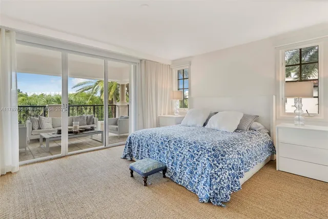 a bedroom with a bed and large window