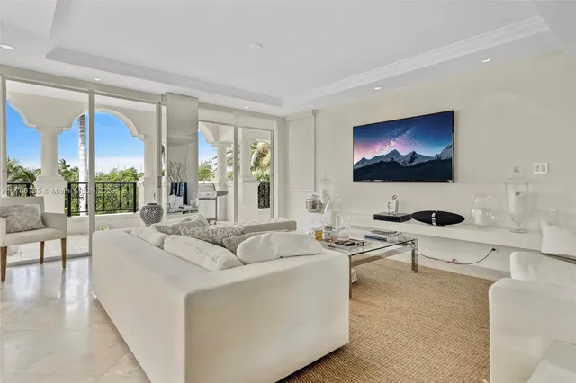 a living room with couches a coffee table and a flat screen tv