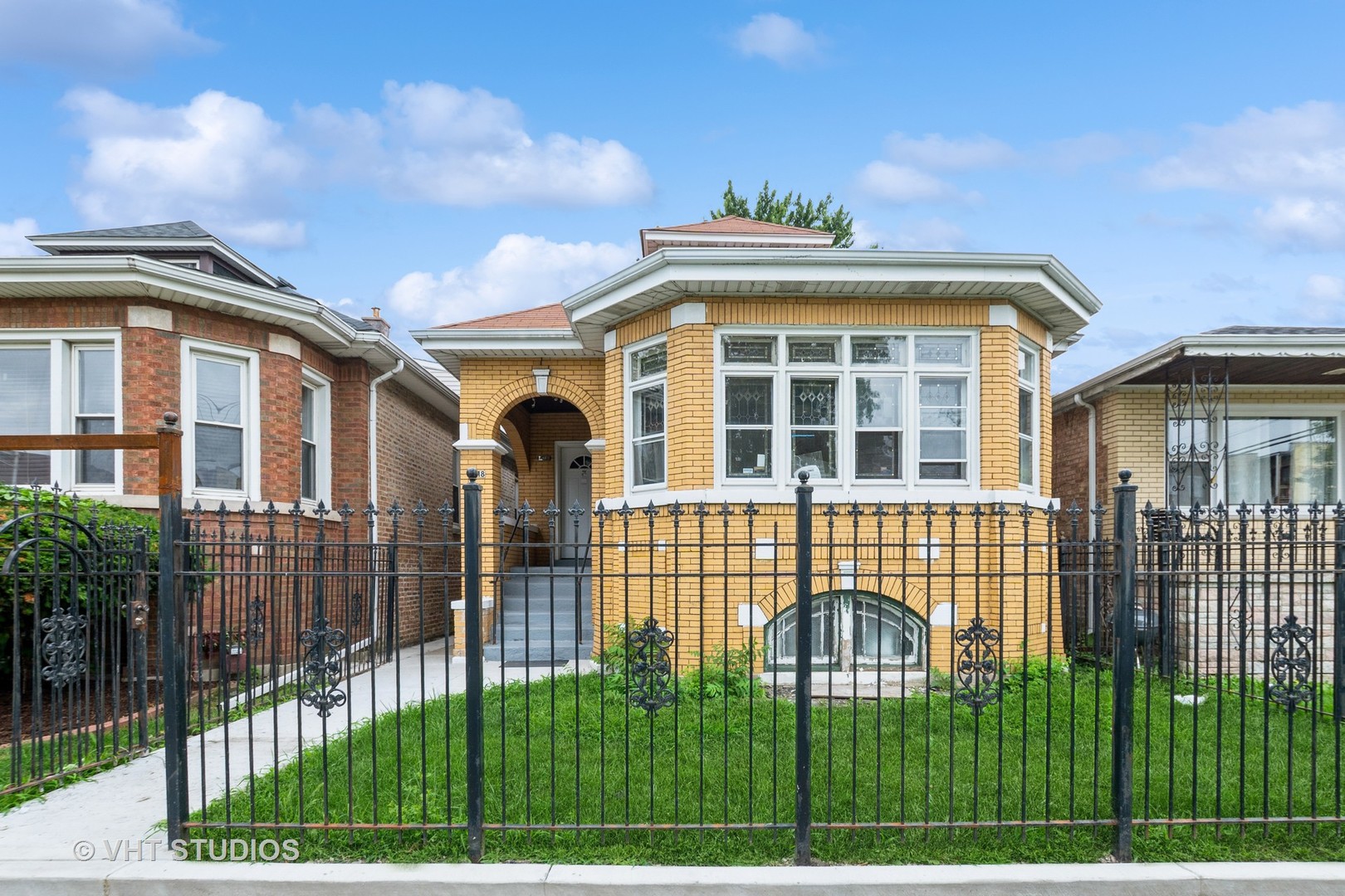 8718 South Marshfield Avenue Chicago, IL 60620 - Photo 1 of 10 a view of a brick building next to a yard