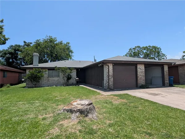 a view of a house with a yard and potted plants