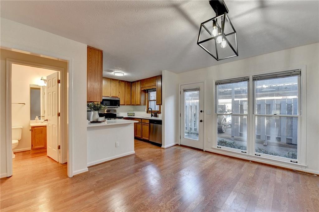 3492 Tulip Tree Lane Duluth, GA 30096 - Photo 13 of 35 a view of a kitchen with refrigerator and wooden floor