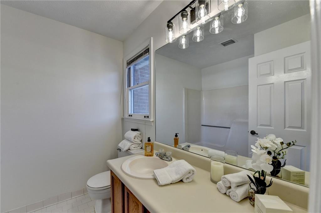 3492 Tulip Tree Lane Duluth, GA 30096 - Photo 16 of 35 a bathroom with a granite countertop sink a toilet and a mirror