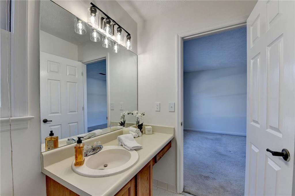 3492 Tulip Tree Lane Duluth, GA 30096 - Photo 17 of 35 a bathroom with a sink and a mirror