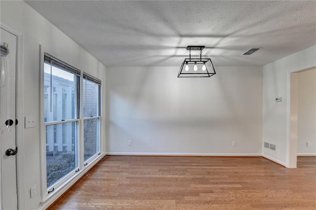 3492 Tulip Tree Lane Duluth, GA 30096 - Photo 32 of 35 a view of empty room with wooden floor and windows