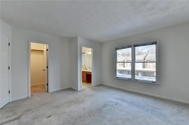 an empty room with windows and closet