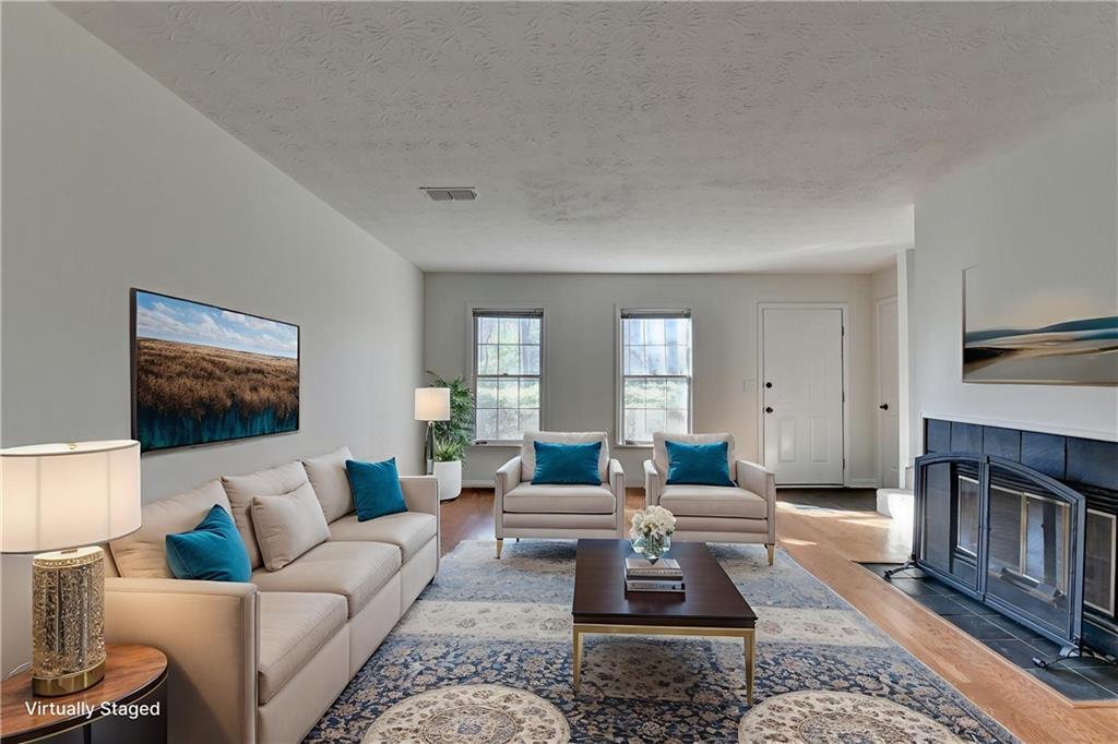 3492 Tulip Tree Lane Duluth, GA 30096 - Photo 7 of 35 a living room with furniture wooden floor and a flat screen tv