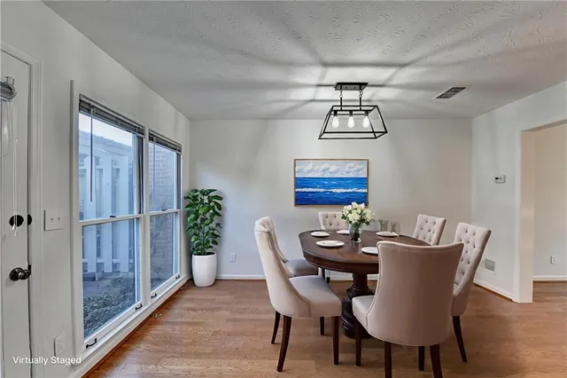 a view of a dining room with furniture wooden floor and a chandelier