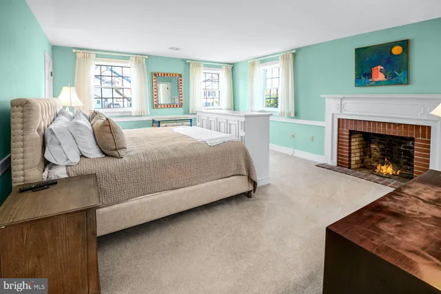 a bedroom with a bed and a fireplace