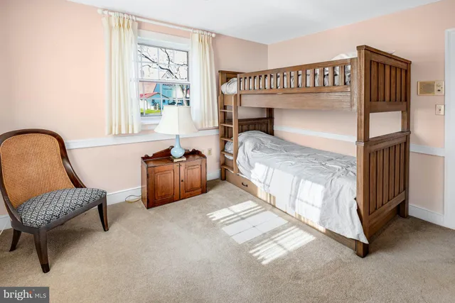 a bed room with a bed and a chair