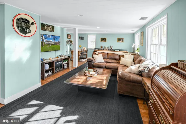 a living room with furniture a window and a clock