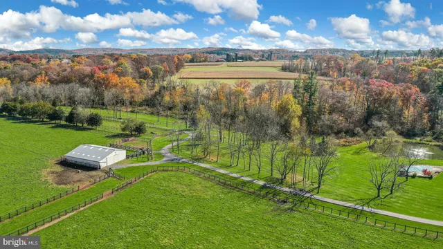 an aerial view of a house with a garden and lake view