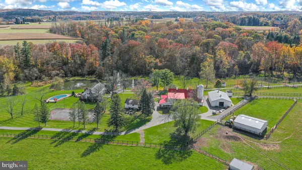 a view of a tennis ground with a table and chairs