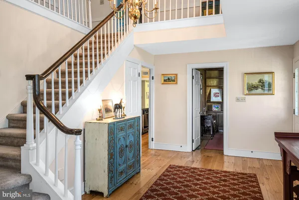 a view of entryway with wooden floor and stairs