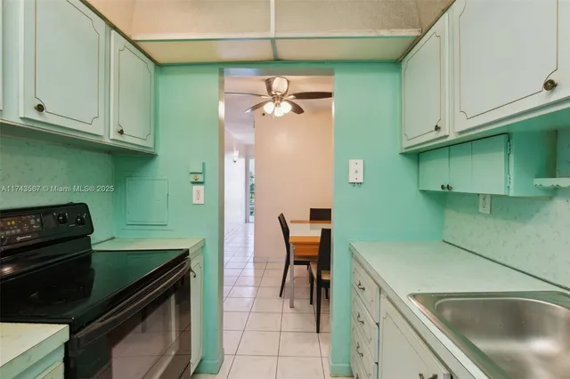 a kitchen with a cabinets and a stove top oven