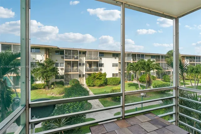 a view of a glass door with a tree in it