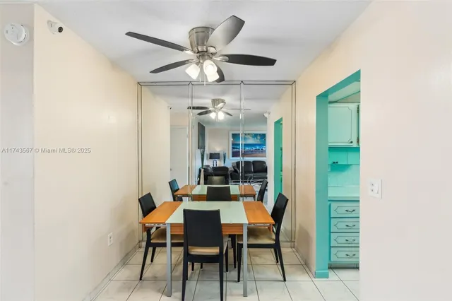 a view of a dining room with furniture and a chandelier fan