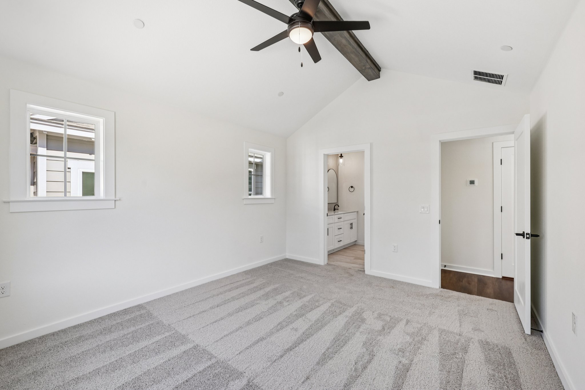 2414 Drew Lane, Unit 3 Austin, TX 78748 - Photo 13 of 18 Unfurnished bedroom featuring light colored carpet, ensuite bath, and a ceiling fan